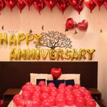Anniversary decoration with heart shaped foil and red balloons