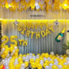 Birthday party theme decoration with balloons on ceiling and floor, happy birthday foil, age foil balloon on balloon contain pillar, star foil, champagne bottle foil balloon and frill ribbons