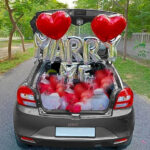 Best proposal decoration with marry me foil balloon, red heart shape foil and balloon, confetti balloons, balloon spread on car boot and 10 red rose flower bouquet