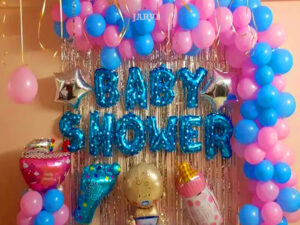 Simple baby shower decoration with baby shower foil 2 star shape foil, moon shape foil, milk bottle shape foil. Foot shape foil balloon, swing shape foil balloon, foil curtain, and 50 metallic balloons on the ceiling with ribbon air-filled