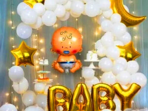 Baby shower decoration Indian style with backdrop stand with white curtains and led lights, white latex balloons, moon foil, baby foil and golden star foil balloon
