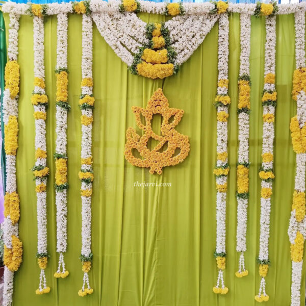 Haldi/Mehendi decoration at home using Ganesh Ji Made With White Artificial Flowers along with String Artificial Flower.