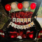 Happy birthday bunting car decoration: two heart-shaped foil balloons, frill ribbon, and round-shaped red and white balloons