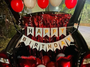 Happy birthday bunting car decoration: two heart-shaped foil balloons, frill ribbon, and round-shaped red and white balloons