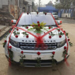 Marriage car decoration with bouquet, small bow and red roses